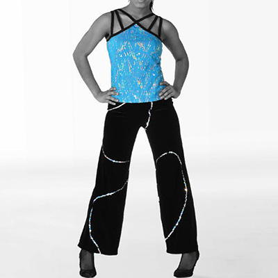 Grayscale model wearing black velvet wide leg pants with silver sequin trim paired with a turquoise and silver spotlight sequin patterned top with black straps and trim at the neckline.